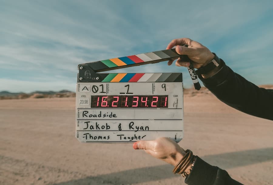A clapperboard held up against a desert sky reading Roadside, take nine