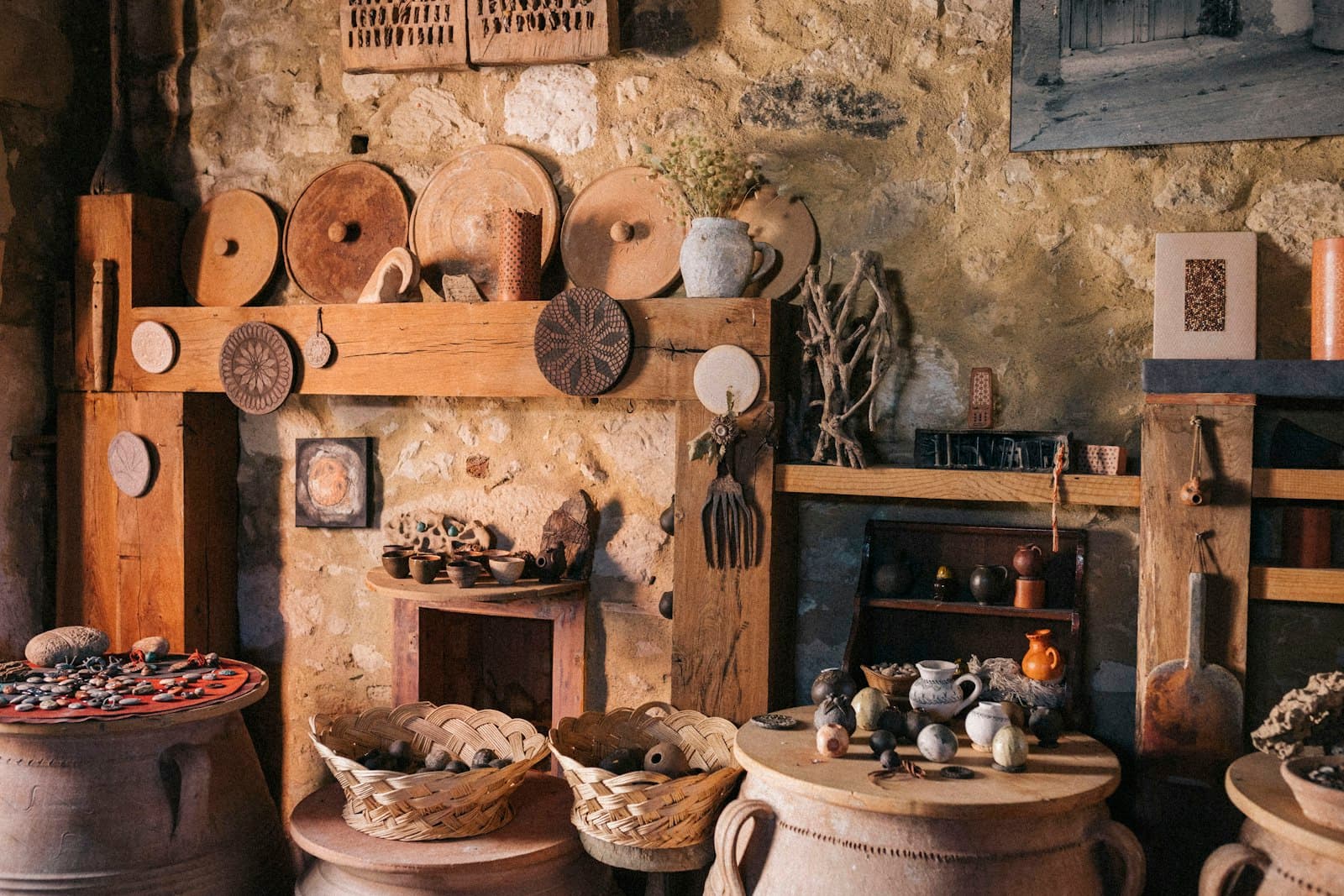 Shelves crowded with finished clay pots and woven baskets